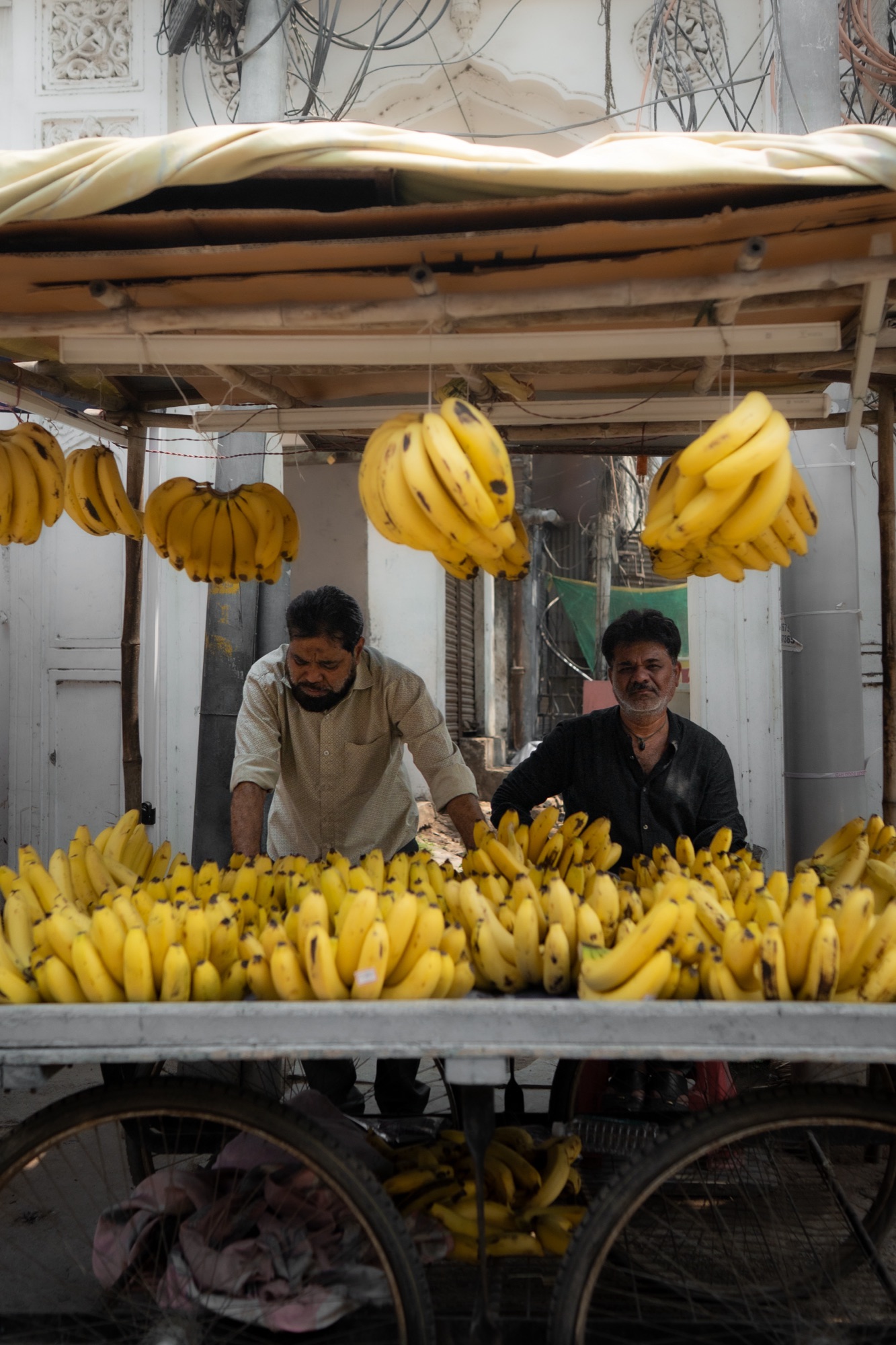 Banana stand vendors at a street market