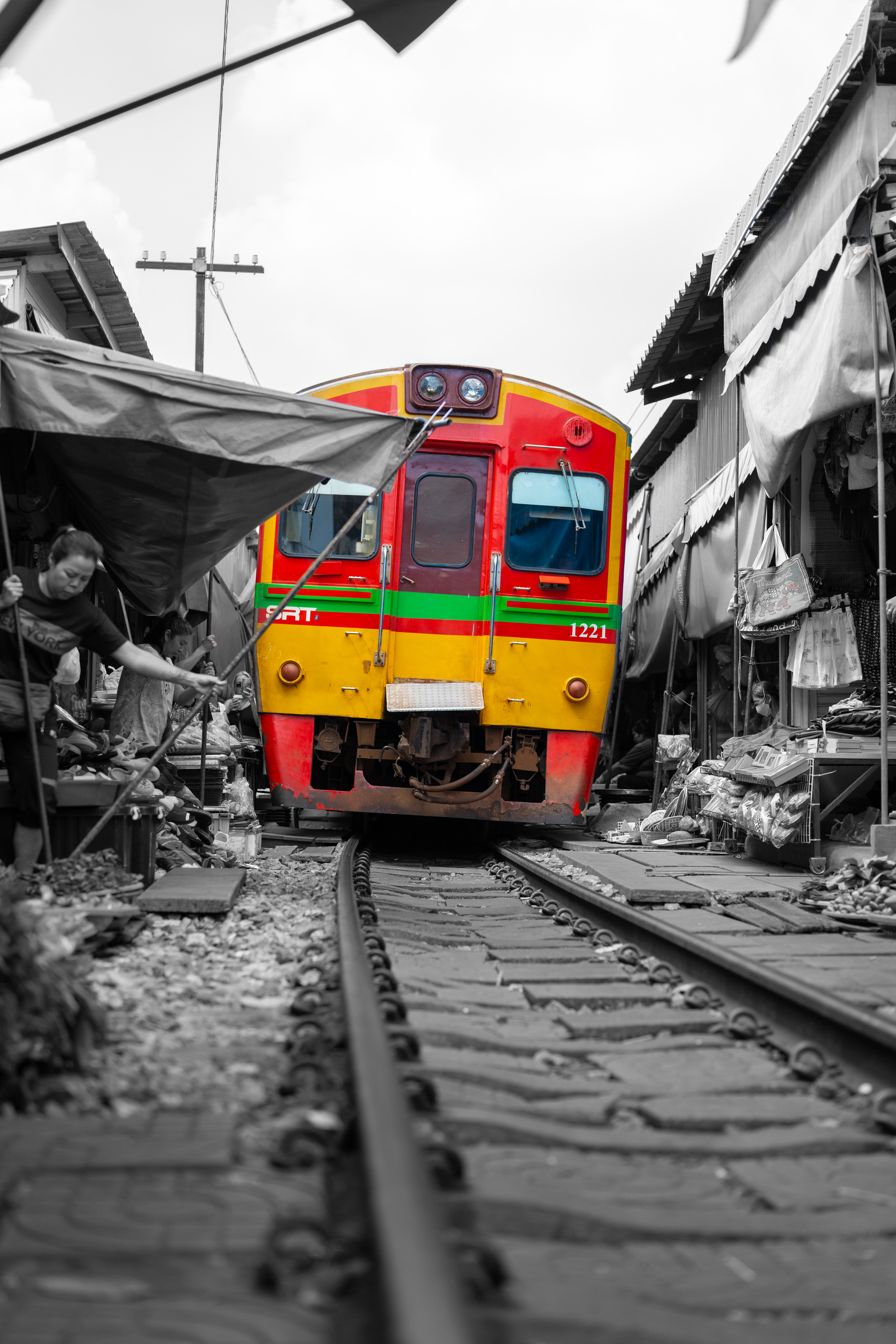 Train passing through the Maeklong Railway Market, Thailand